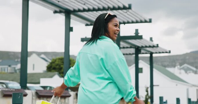 Smile, woman and shopping with bag in city for travel, retail purchase and customer experience. Excited, female person and dancing with package for urban bargain, commercial spree and boutique sales