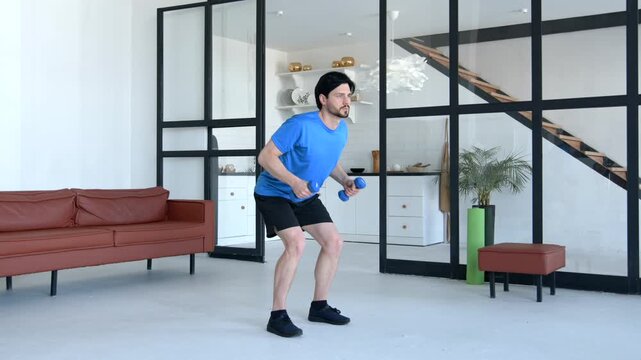 Athletic fit man in activewear practicing bent over dumbbell row workout , flexing and strengthening back, arm and shoulder muscles, building core stability during indoor sports training