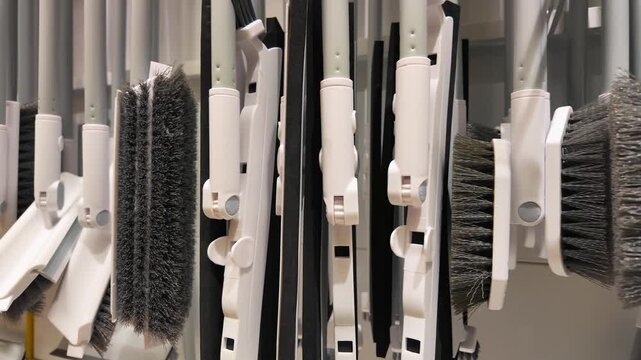 Retail Display of White Cleaning Brushes and Brooms