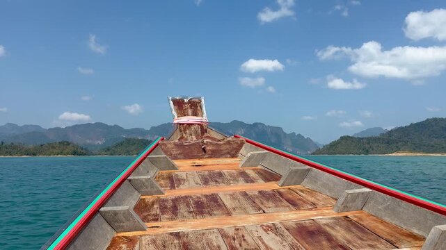 Bow of the boat moving through the beautiful limestone cliffs on the lake in Kao Sok National Park in Thailand