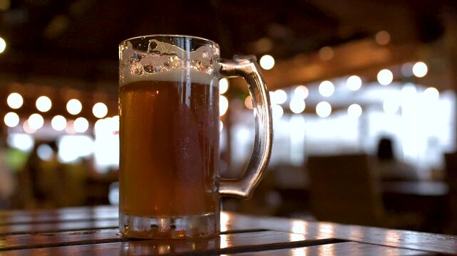 Cold Glass Mugs of Frothy Lager Beer on a Bar Table