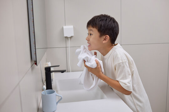 Boy freshening up in the bathroom