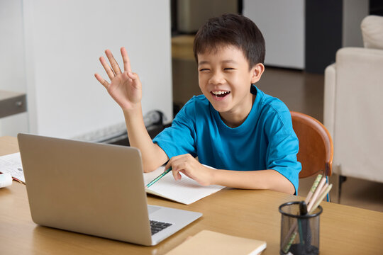 Boy attending an online lesson at home
