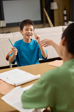 Boys tackling homework at the kitchen table