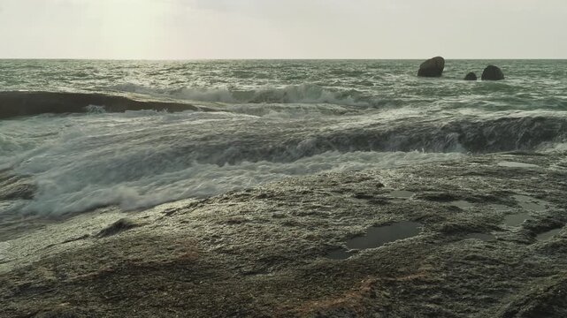 Ocean waves over big rocks