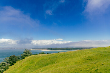 Obraz premium Coastal Hillside Under Bright Blue Summer Sky