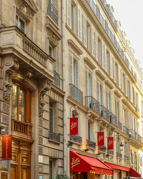 Paris, France - October 13, 2025: Parisian Haussmann building featuring balconies, windows, and Flottes restaurant awning