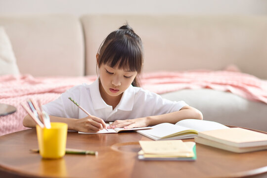 A girl doing her homework at her desk
