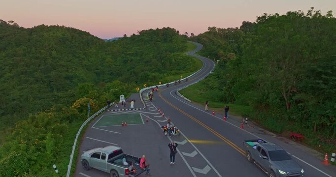 Aerial drone view of a picturesque mountain road shaped like the number three in Nan Province. This famous viewpoint attracts travelers and photographers seeking breathtaking curves and stunning