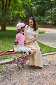 Mum and her daughter go roller skating in the park