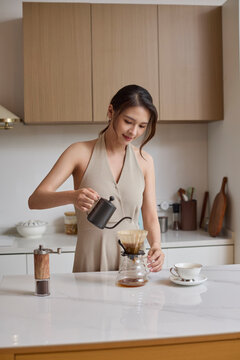 A beautiful woman making coffee by hand