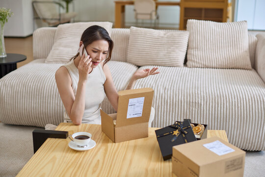 Elegant woman unpacking the packages from online shopping