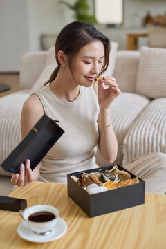 Elegant woman unpacking the packages from online shopping