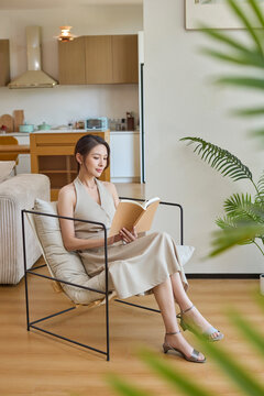 Graceful woman utterly absorbed in the world of her book