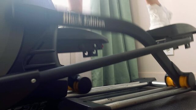 Close up of elliptical trainer pedals in motion at home