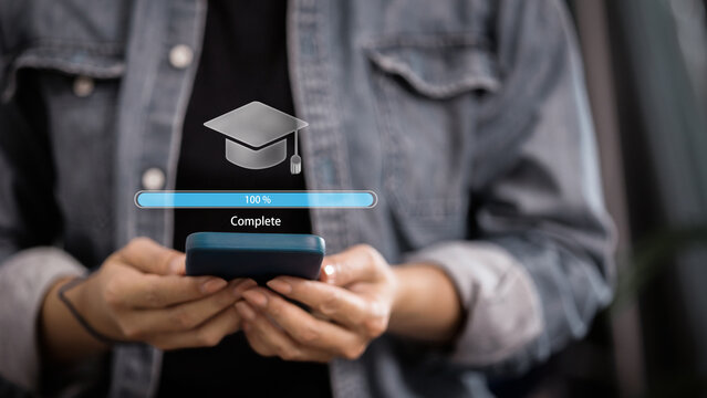 Person holding smartphone with 100 percent complete progress bar and graduation cap icon.