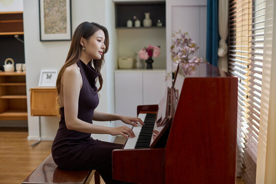 Elegant woman playing piano