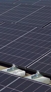 A rooftop solar power plant. Solar panels on the roof of an apartment building. Vertical video. 