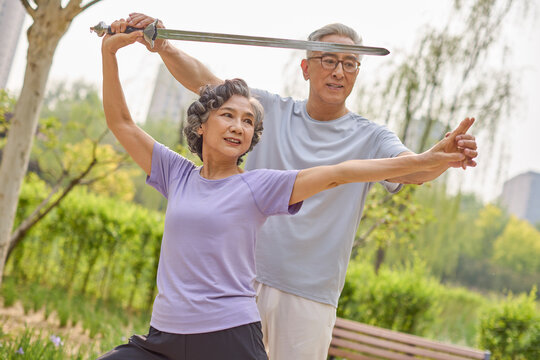 Some seniors performing a sword dance in the park