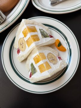 Japanese style fruit sandwich with whipped cream on a white plate