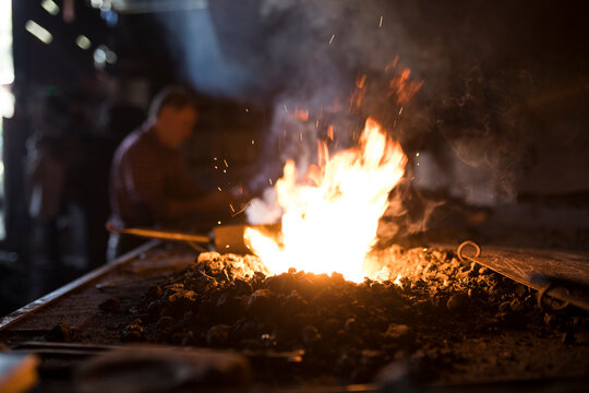 Forge in workshop with blacksmith in background