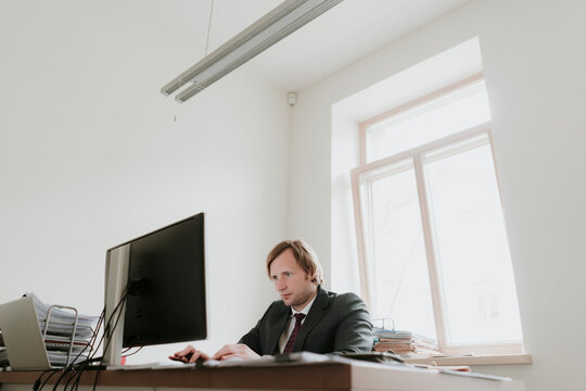 Businessman using computer at desk in office