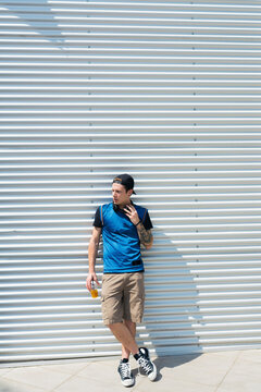 Tattooed young man with drink