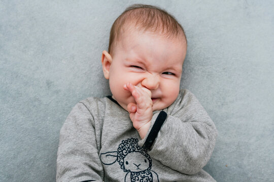 Portrait of baby girl pulling funny faces