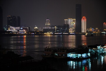 Obraz premium Night cityscape with high rise buildings and water reflection