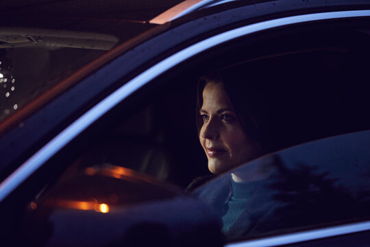 Portrait of confident woman in car at night