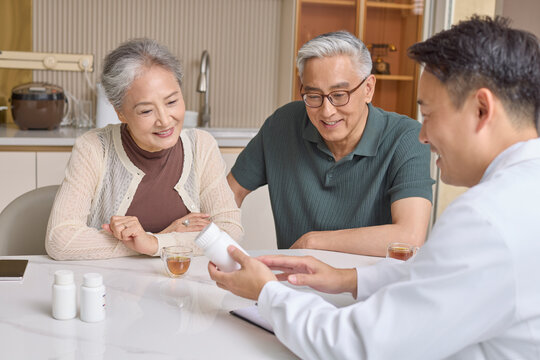 An elderly couple consulting their family doctor