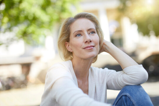 Portrait of smiling blond woman looking at distance