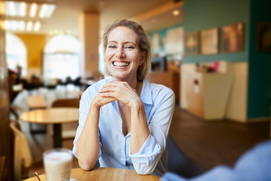 Portrait of happy woman in a cafe