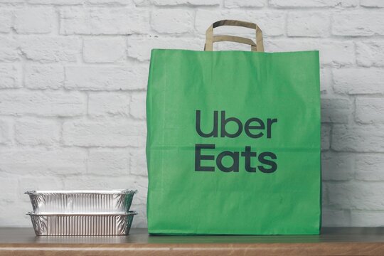Neu-Ulm, Germany - March, 16, 2026: Paper bag with food from Uber eats delivery service on the table. 