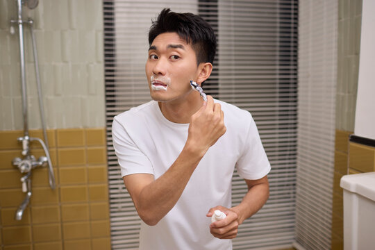A man shaving in the bathroom