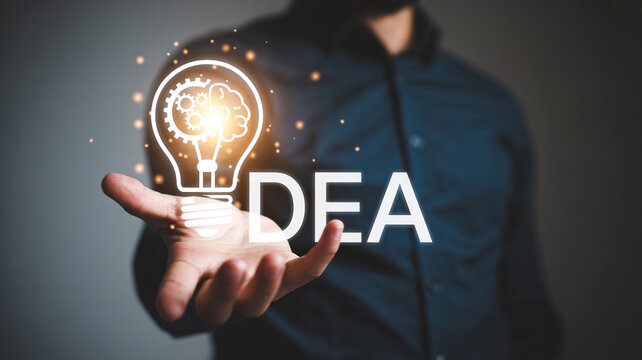 Man presenting a glowing lightbulb with gears and brain inside, representing idea generation and creative thinking