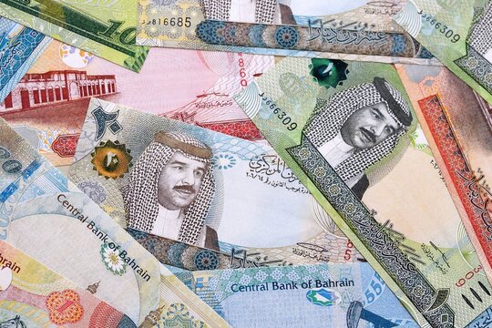 Bahraini dinar money bills pile on table. Bahrain banknotes of BHD currency close up.