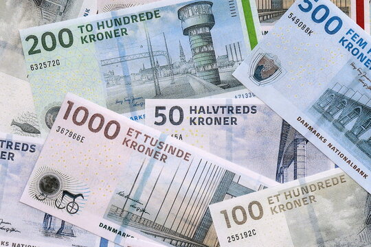 Danish krone money bills pile on table. Denmark banknotes of DKK currency close up.