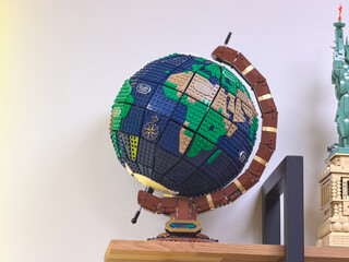 Naklejka premium Lego globe model on wooden shelf
