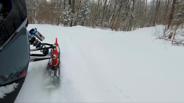 Looking at the ski of a snowmobile during the ride.