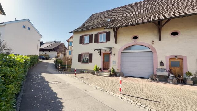 An old beige farmhouse in Tumringen with a large barn door in L&ouml;rrach, Germany