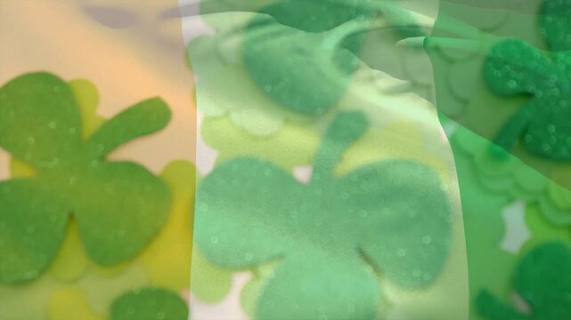 Camera pull causing tricolor panel rippling and folding revealing glitter shamrocks for craft
