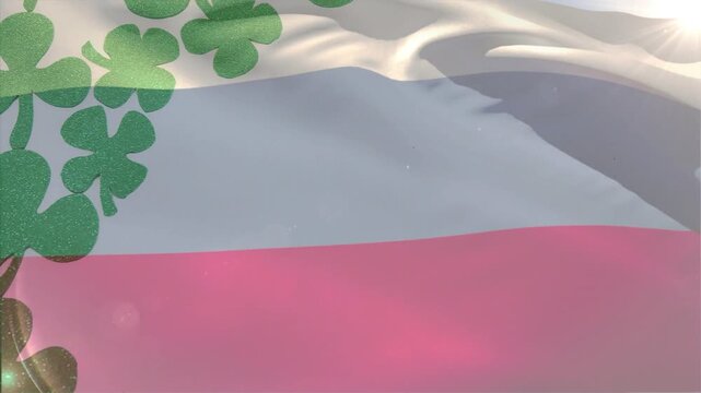 Flag fabric waving from light breeze, clover motif emerging as folds shift to reveal bands