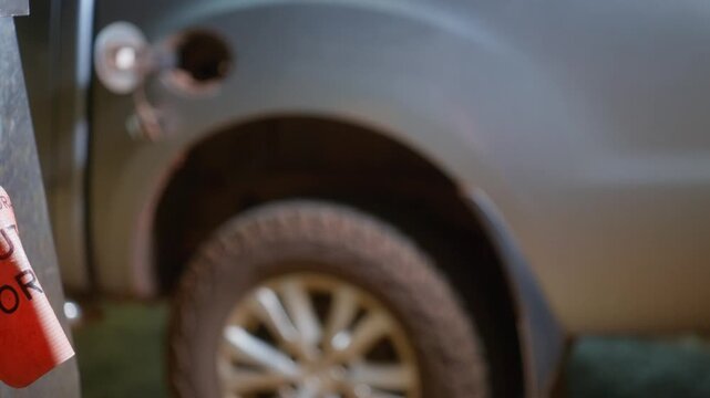 4x4 vehicle at a service station at night where the fuel bowser displays an &lsquo;Out of Order No Fuel Available&rsquo; sign. Sliding shot, clip 6