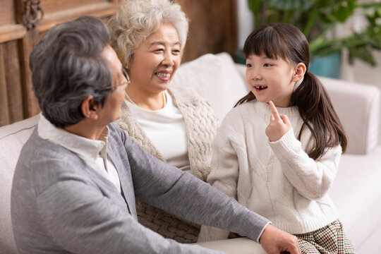 Granddaughter showing her grandparents the gap from her missing tooth