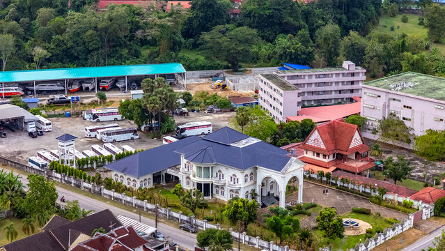 Tourist buses parked at depot Koh Siray Phuket aerial