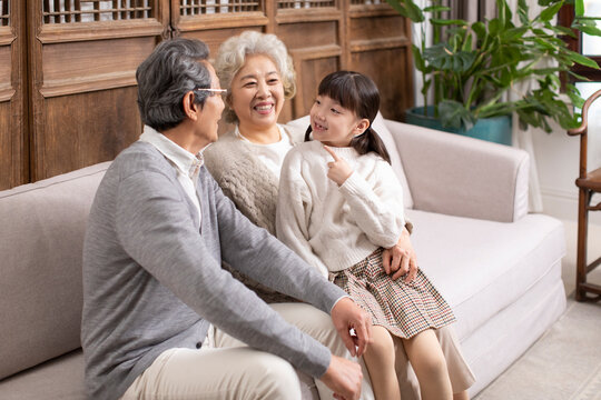 Granddaughter showing her grandparents the gap from her missing tooth