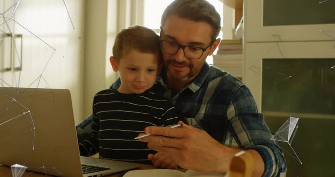 Father presenting white device to son on wooden table, guiding grip and teaching tech via laptop