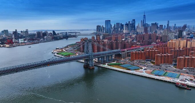 Approaching the East Side River Park and lively FDR Drive. View on the steel suspension Williamsburg Bridge against Manhattan Skyline.