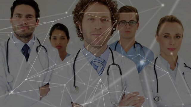 Medical team standing, network animation starting on cue, shifting across portrait centering doctor